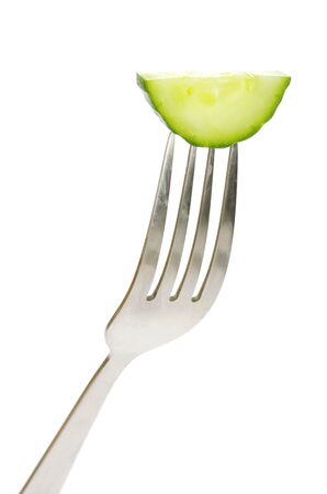 fresh cucumber on a forkの写真素材