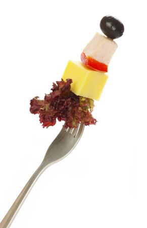 Fresh vegetables on a fork isolated on white backgroundの写真素材