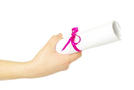 Diploma with a red ribbon in hand isolated on white の写真素材