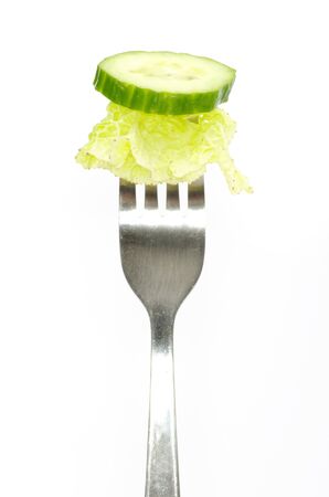 fresh cucumber on a forkの写真素材