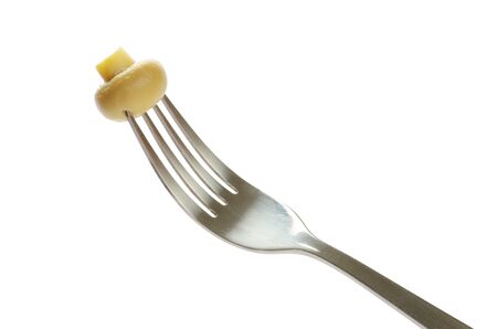 Fresh mushroom on a fork isolated on white backgroundの写真素材