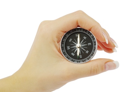 Compass in a hand isolated on the whiteの写真素材