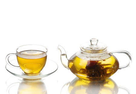 Tea being poured into glass tea cupの写真素材