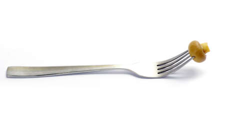 Fresh mushroom on a fork isolated on white background