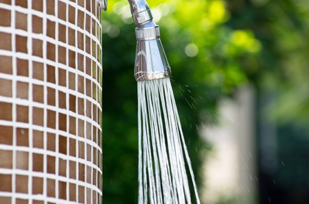Tropical refreshing shower under palm treesの写真素材