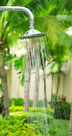Tropical refreshing shower under palm treesの写真素材
