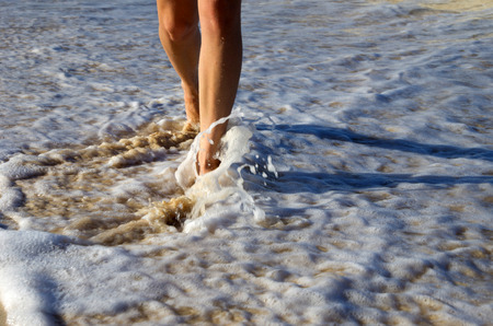 Footprints in wet sand of beachの写真素材