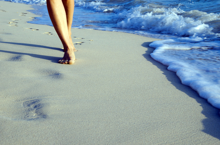 Footprints in wet sand of beachの写真素材