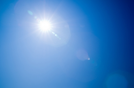 Shining sun at clear blue skyの写真素材