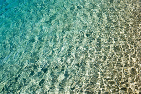 Blue water with sun reflections