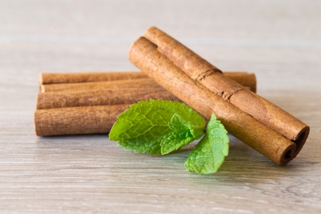Mint with cinnamon on wood backgroundの写真素材