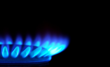 Blue flames of gas stove in the dark         の写真素材