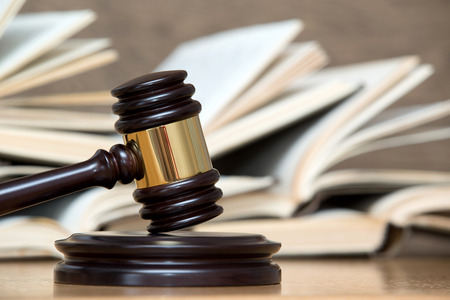 wooden gavel and books on wooden tableの写真素材