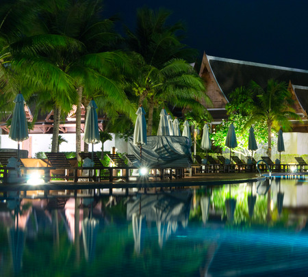 swimming pool in night illuminationの写真素材