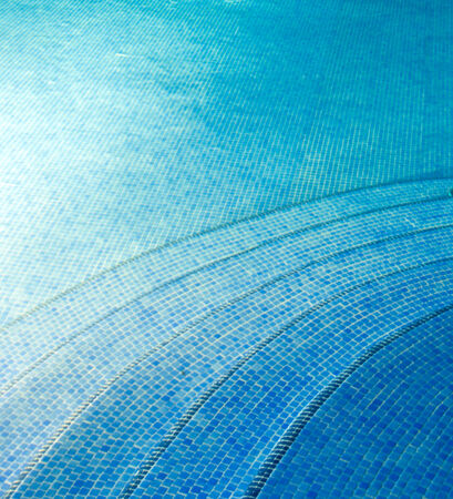 Blue pool water with sun reflectionsの写真素材