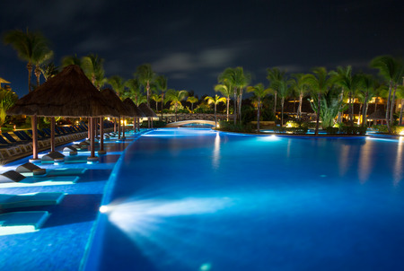 swimming pool in night illuminationの写真素材