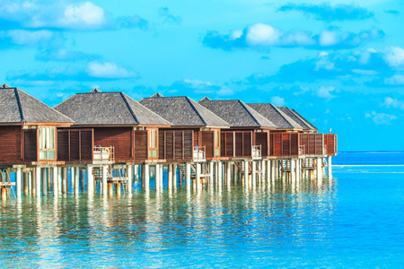 beach with water bungalows at Maldivesの写真素材