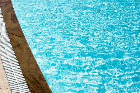 Blue pool water with sun reflectionsの写真素材