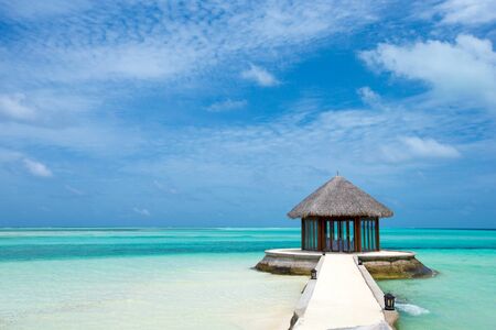tropical beach in Maldives with few palm trees and blue lagoonの写真素材