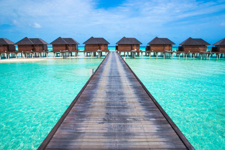 beach with water bungalows at Maldivesの写真素材