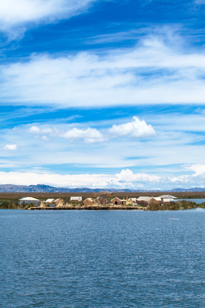 PERU - MAY 11, 2015: Unidentified women in traditional dresses welcome tourists in Uros Islandのeditorial素材