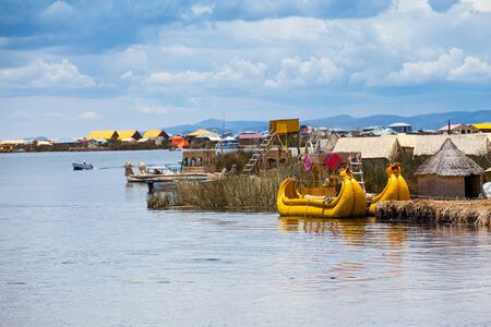 PERU - MAY 11, 2015: Unidentified women in traditional dresses welcome tourists in Uros Islandのeditorial素材