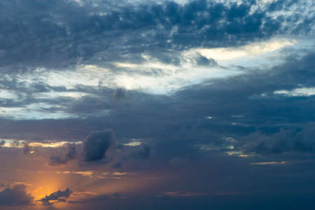 Sunset with sun rays, sky with clouds and sun.