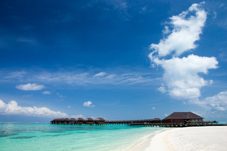 beach with water bungalows at Maldivesの写真素材