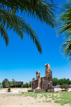 Egypt. Luxor. The Colossi of Memnon - two massive stone statues of Pharaoh Amenhotep IIIの写真素材