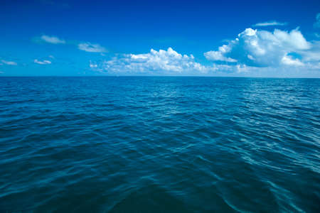Beautiful white clouds on blue sky over calm seaの写真素材
