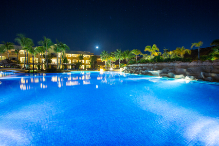 Swimming pool at a luxury Caribbean, tropical resort at nightのeditorial素材
