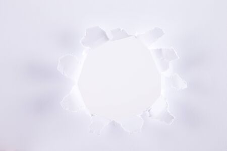 Hole in the paper with torn sidesの写真素材