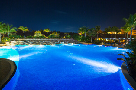 swimming pool in night illumination. tropical resort at nightのeditorial素材