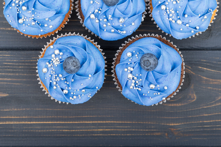 Tasty cupcakes on a white wooden tableの写真素材