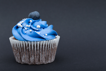 Delicious birthday cupcake on black backgroundの写真素材