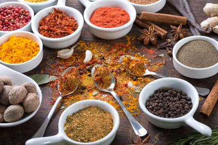 Herbs and spices in ceramic bowls. Aromatic ingredients and natural food additives.の写真素材