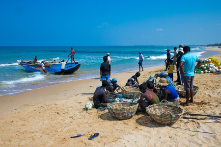 SRI LANKA - Mach 23: Local fishermen pull a fishing net from Indian Ocean on Mach 23, 2017 in Kosgoda, Sri Lanka. Fishing in Sri Lanka is the way they earn their living.のeditorial素材