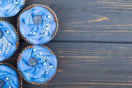 Tasty cupcakes on a white wooden tableの写真素材