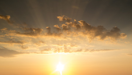 Sunset with sun rays, sky with clouds and sunの写真素材