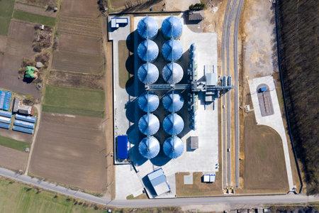 Granary elevator. Silver silos on agro-processing and manufacturing plant for processing drying cleaning and storage of agricultural productsの写真素材