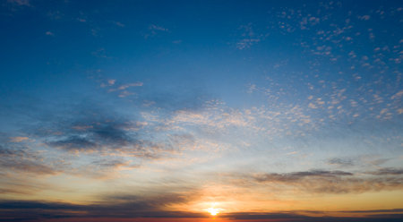Sunset with sun rays, sky with clouds and sun.の写真素材