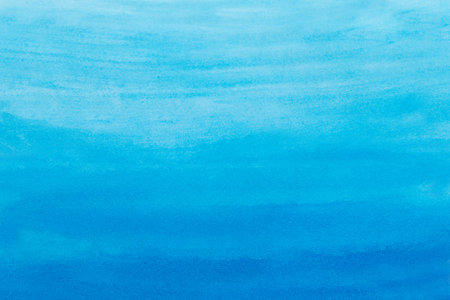Abstract blue watercolor background. The color splashing on the paper. hand drawn.の写真素材
