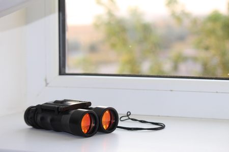 Binoculars on the windowの写真素材