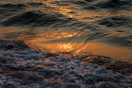 Beautiful waves in the rays of dawnの写真素材
