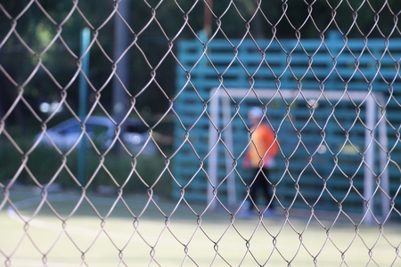 Football player behind the fenceの写真素材