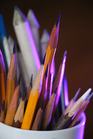 Pencils for drawing in a glass in the light of a lampの写真素材