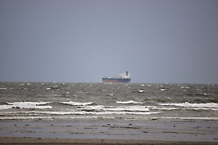 ISLAMABAD / PAKISTAN . Pakistani father playing with kids at Clifton Beach and backgroupd is huge cargo ship arabian sea Karachi Clifton beach 20 April 2012     のeditorial素材