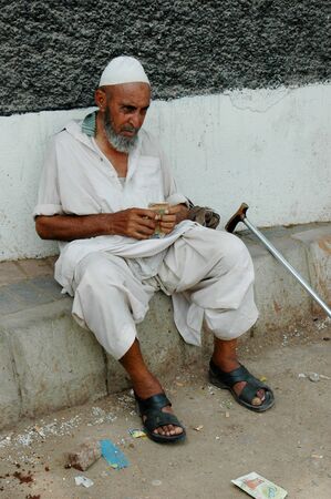 PAKISTAN_KARACHI_ Pakistani senior male counting Pakistani currency called repuees notes 18 May 2012  
のeditorial素材
