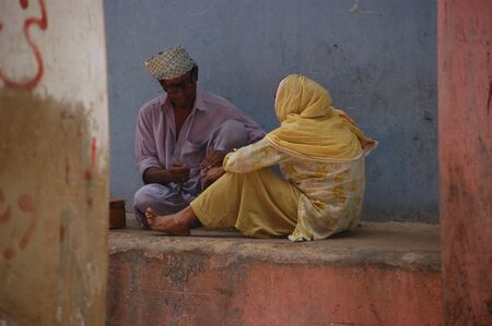 PAKISTAN_KARACHI_pakistani christian couple barber cuting nails of woman outside of house in street in karachi.on june,24,2012のeditorial素材
