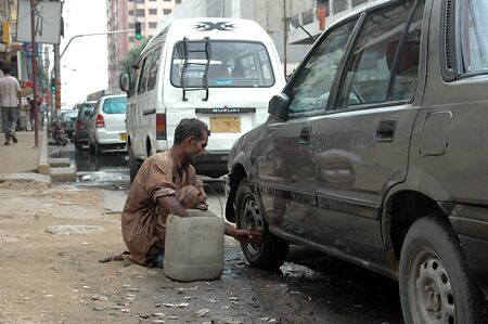 KARACHI/PAKISTAN_Pakistani male maunally washing was  hard working Pakistan man 13 August 2012           のeditorial素材